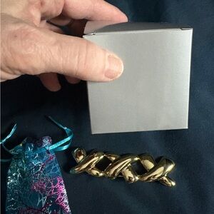 Gold , triple X, brooch